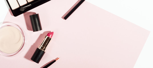 Makeup cosmetics top view on pink trendy background. Beauty elegant backdrop with copyspace. Eye shadows, lipstick, powder items for facial care. Women accessories. Fashion glamour composition.