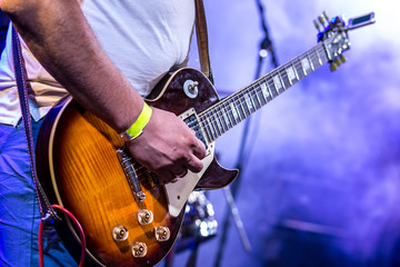 Obraz premium Stage lights.Playing guitar and concert concept.Live music background.Rock concert.Music festival.Instrument on stage and band,bass guitarist.