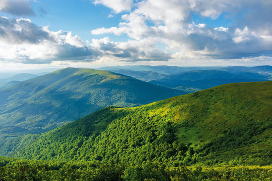 summer afternoon in mountains. wonderful landscape of green carpathian. beautiful fluffy clouds on a blue sky above the ridge. travel freedom concept.
