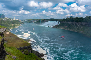 aerial view of niagara falls with rainbow and a boat