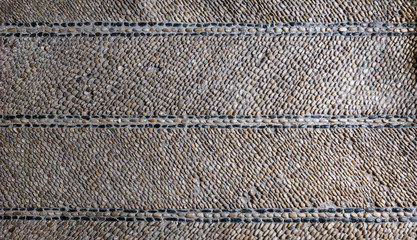 Pavement at the entrance of the inquisitor's house in Cartagena, made in white, beige and black oval stones with line and diagonal design