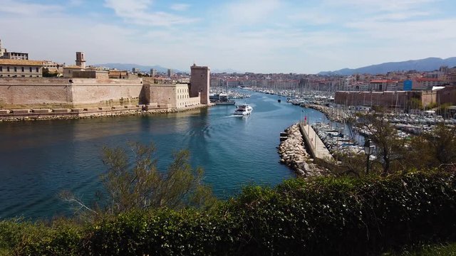 Marseille city, France. Panoramic view on old town port entrance. UHD 4K cinematic stock footage about French Riviera, Mediterranean Coast, South European life, travel, culture.