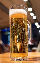 A large glass of German beer on a table