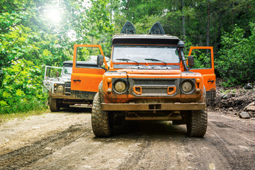 Dirty Four wheel drive truck 4x4 with all terrain tires parked in the forest © petrrgoskov