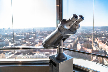 telescope on observation deck aimed at city center