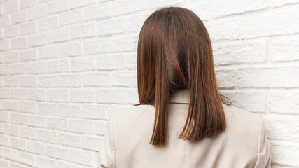 Young business woman from behind, looking back