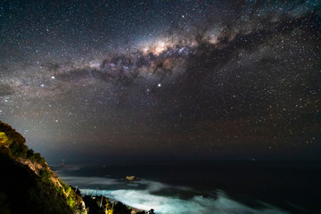 Fototapeta na wymiar A view of the Milky Way from the southern hemisphere an amazing night sky view above Pacific Ocean sea on a fantasy landscape full of stars with the center of the galaxy showing us its magnificence