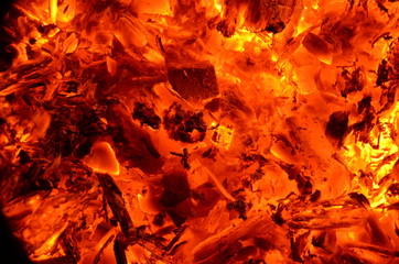 Burning coal anthracite mixed with wood as a bright background.