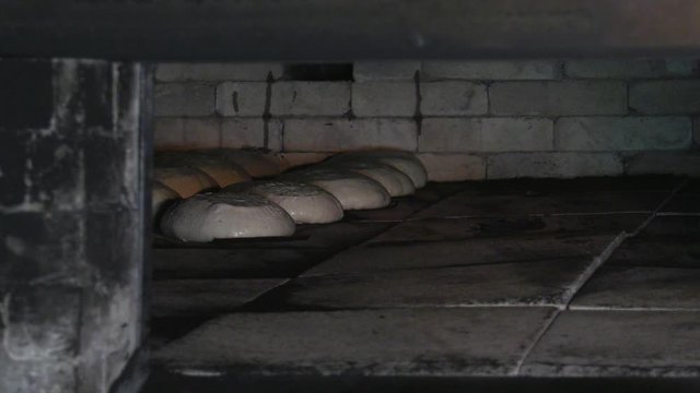 Baking bread in a traditional wood-burning oven.