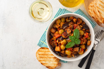 Traditional sicilian eggplant dish Caponata in bowl on concrete background. Top view. Copy space.