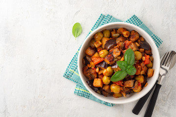 Traditional sicilian eggplant dish Caponata in bowl on concrete background. Top view. Copy space.