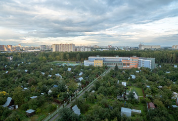 Panoramic view of residential new buildings of the city, surrounded by trees.