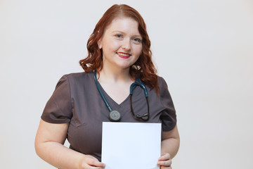 Portrait of a young female healthcare professional, a woman nurse against a white with copy space