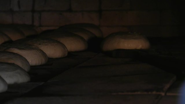 Baking bread in a traditional wood-burning oven.