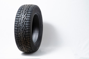 Winter car tires with spikes. Car tires on white background. Shop tires and wheels.
