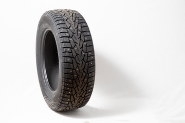 Winter car tires with spikes. Car tires on white background. Shop tires and wheels.