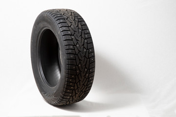 Winter car tires with spikes. Car tires on white background. Shop tires and wheels.