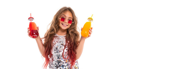Panorama of girl in glittery dress and stylish square red sunglasses, holding two glass bottles with red drink and with yellow drink isolated