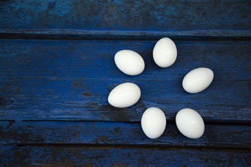 white, chicken egg, on blue wooden shabby background