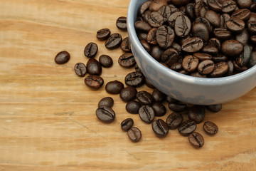 Coffee cup and coffee beans on wooden background. Top view.