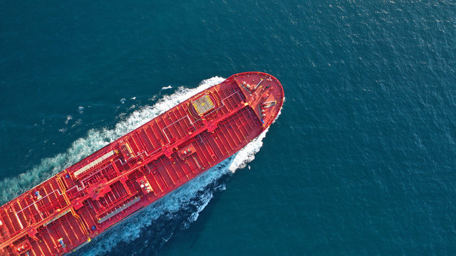 Aerial top down photo of industrial oil and fuel tanker cruising open ocean sea