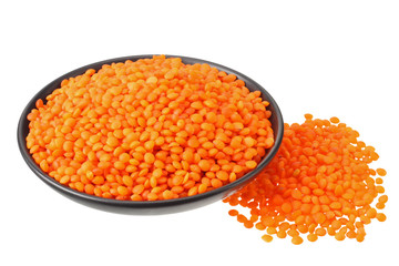 Pile lentil in black bowl isolated on white background