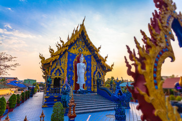 white standing buddha on the back of church in Rong Suea Ten temple Chiang Rai Thailand.