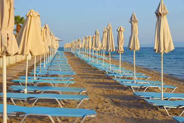 Folded umbrellas on the beach