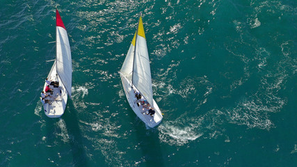 Aerial drone photo of white Sailing boats compete during sailing regatta practise in open ocean exotic sea - obrazy, fototapety, plakaty