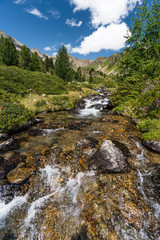 church/chapel close to cliff drop-off above mountain valley