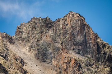 church/chapel close to cliff drop-off above mountain valley