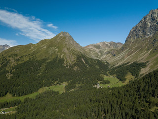 church/chapel close to cliff drop-off above mountain valley