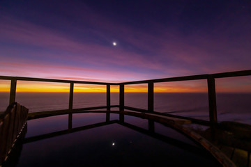 An amazing an idyllic view a wooden hot tub waiting us for some relaxation time during sunset and...