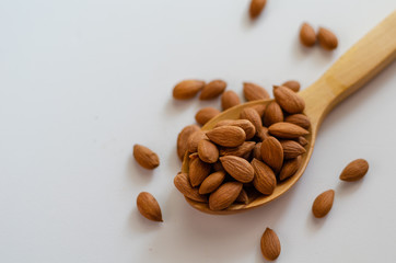 Dried almond nuts in wooden spoon