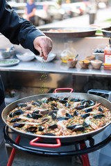 Cooking Spanish Seafood Paella in Traditional Pan