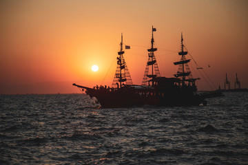An old Greek galleon view from the Aegean sea during sunset
