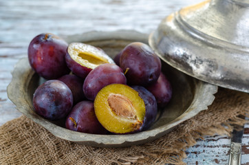 Fresh plums  in copper bowl