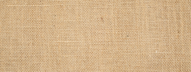 Cotton woven fabric background with flecks of varying colors of beige and brown. with copy space....