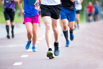 Fototapeta premium Marathon running race, people feet on city road
