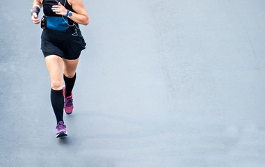 Close up of runner feet. Fitness background, close up of runner feet on the road.