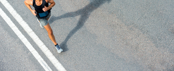 Close up of runner feet. Fitness background, close up of runner feet on the road. - obrazy, fototapety, plakaty