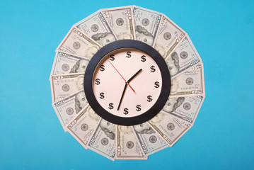 Concept of clock and dollar. Clock on kaleidoscope from money.