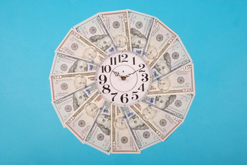 Concept of clock and dollar. Clock on kaleidoscope from money.