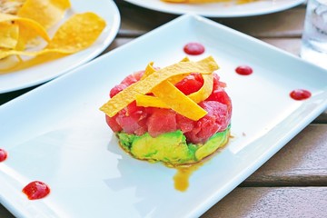Plate of raw tuna poke pressed with fresh avocado