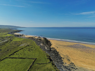 West coast of Ireland, Fanore beach, Sunny day, Blue sky, Atlantic ocean. Nobody. Green fields with dry stone walls.