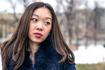 portrait of a beautiful Asian girl looking sideways