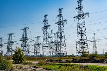 power line poles stand in the field