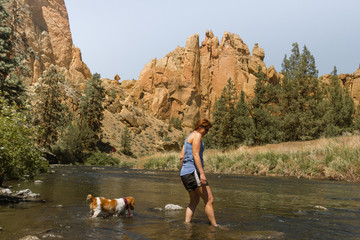 woman and dog river hike