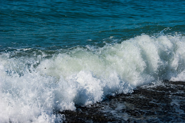 The sea worries once - a light storm at sea, a wave runs onto a pebble beach, the Black Sea coast