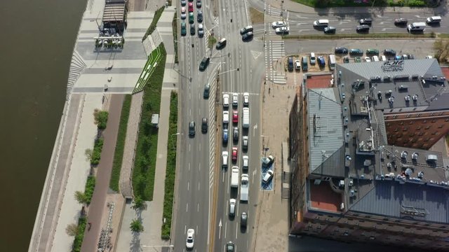 Drone shot on a highway with traffic in the old city of Warsaw. Incredible aerial shot of a freeway, traffic passes through a bridge and an automobile intersection.